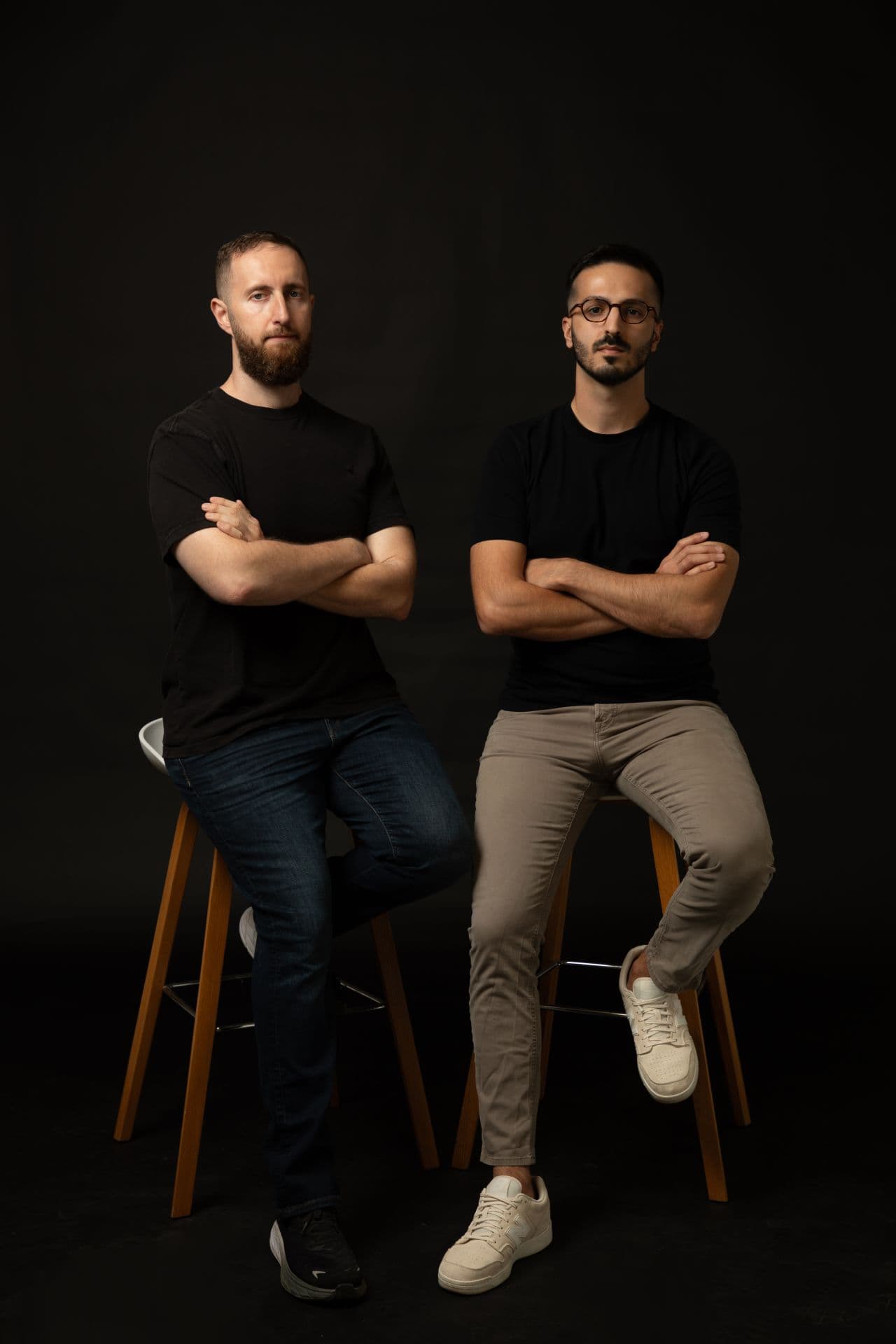 Arthur Azrieli and Michael Zion, the MeteorOps founders, seated on stools against a dark studio backdrop.